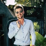 Confident young man in a stylish suit outdoors, exuding charm and elegance.