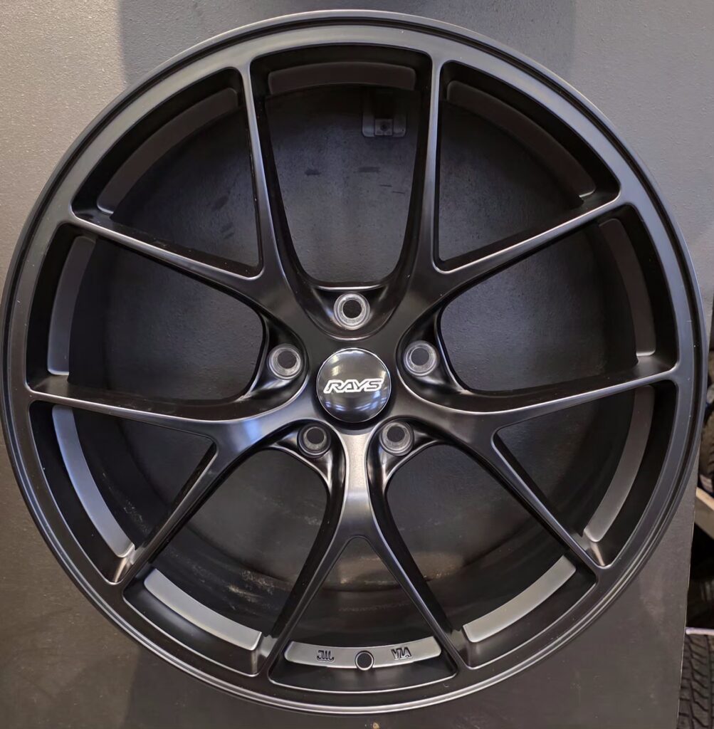 Black alloy car wheel with spokes