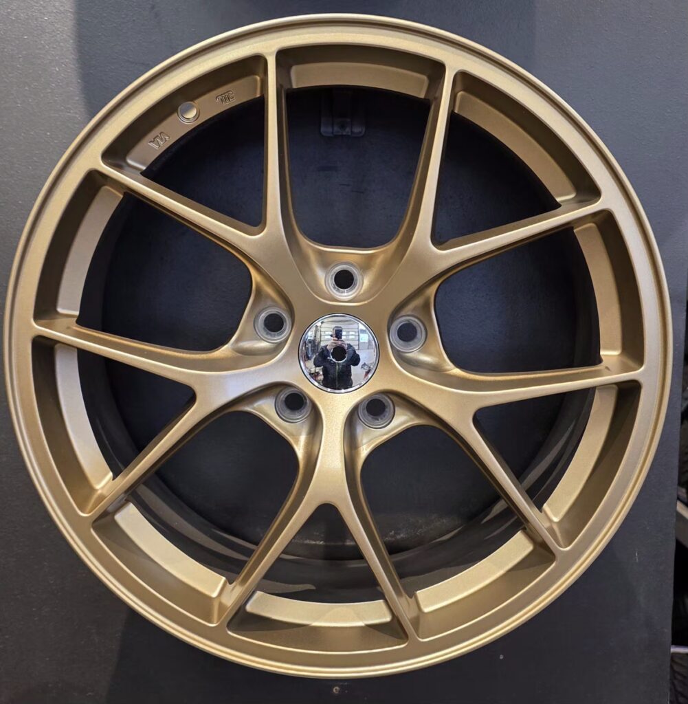 Black alloy car wheel with spokes