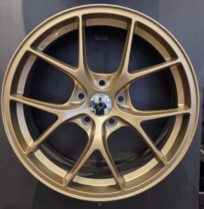 Black alloy car wheel with spokes