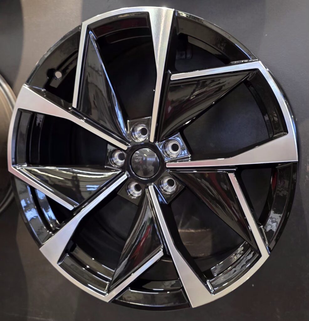 Shiny black and silver car wheel